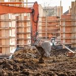 37258585 - industrial truck loader excavator moving earth and leveling a ground hole